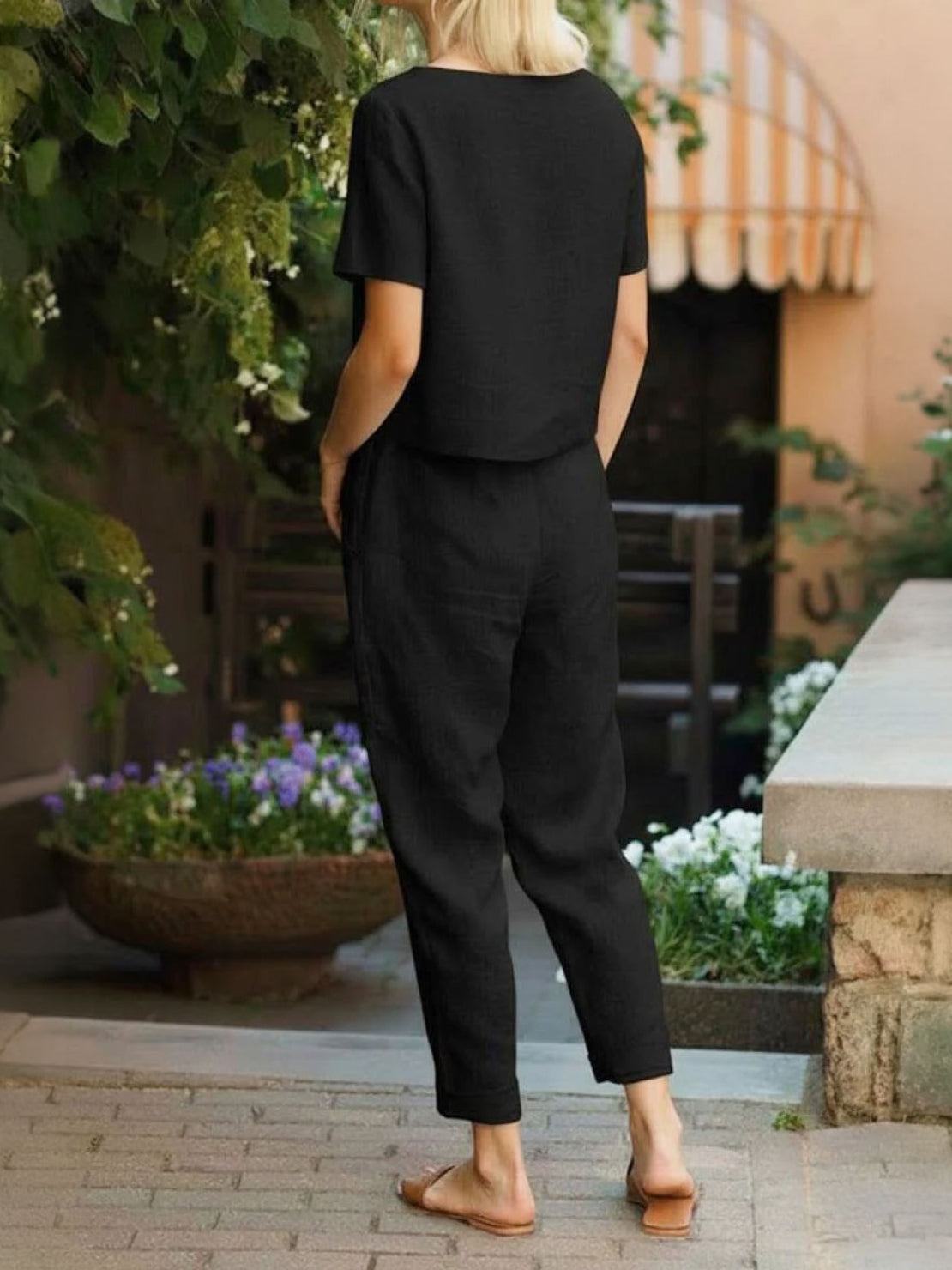 Model wearing breathable 100% cotton linen set with relaxed top and straight-leg pants in monochrome tone