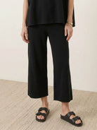 Woman wearing cotton-blend capelet lounge set with mock neck top and wide-leg pants