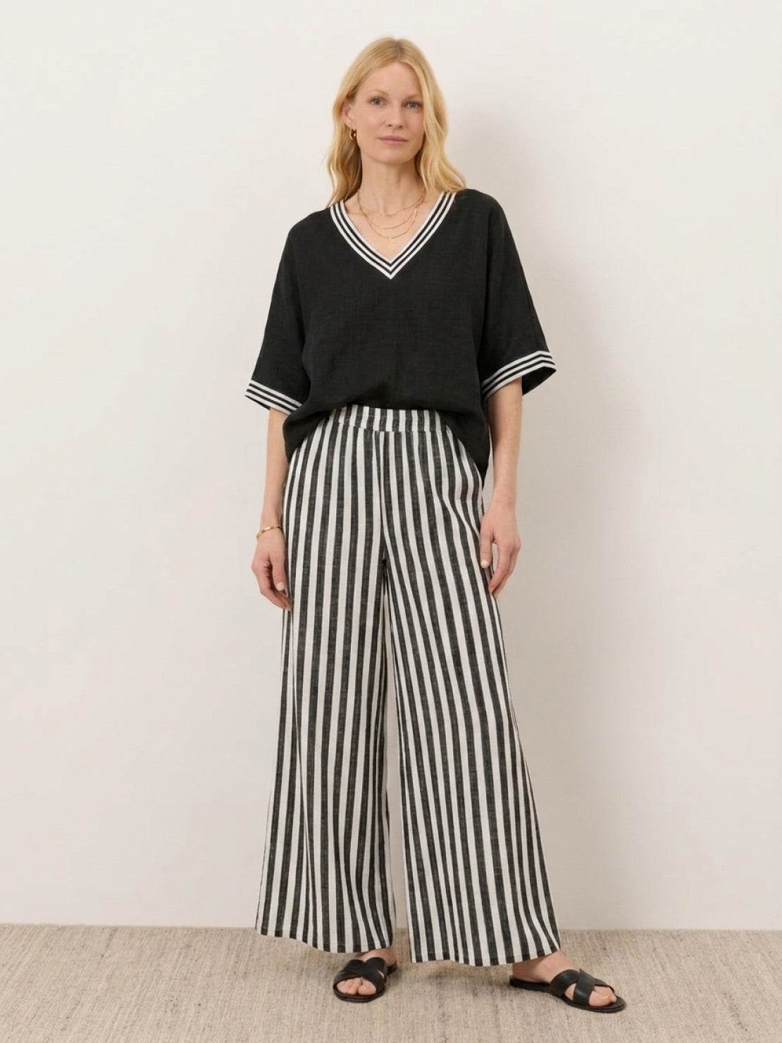 Model wearing striped wide-leg co-ord set with oversized top and palazzo pants with elastic waist and side pockets