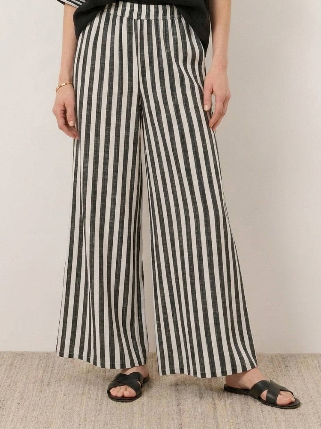 Woman wearing a striped wide-leg co-ord set with oversized top and palazzo pants with elastic waistband and side pockets