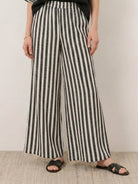 Woman wearing a striped wide-leg co-ord set with oversized top and palazzo pants with elastic waistband and side pockets