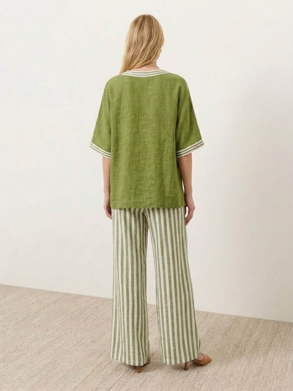 Woman wearing striped wide-leg co-ord set with oversized top and palazzo pants