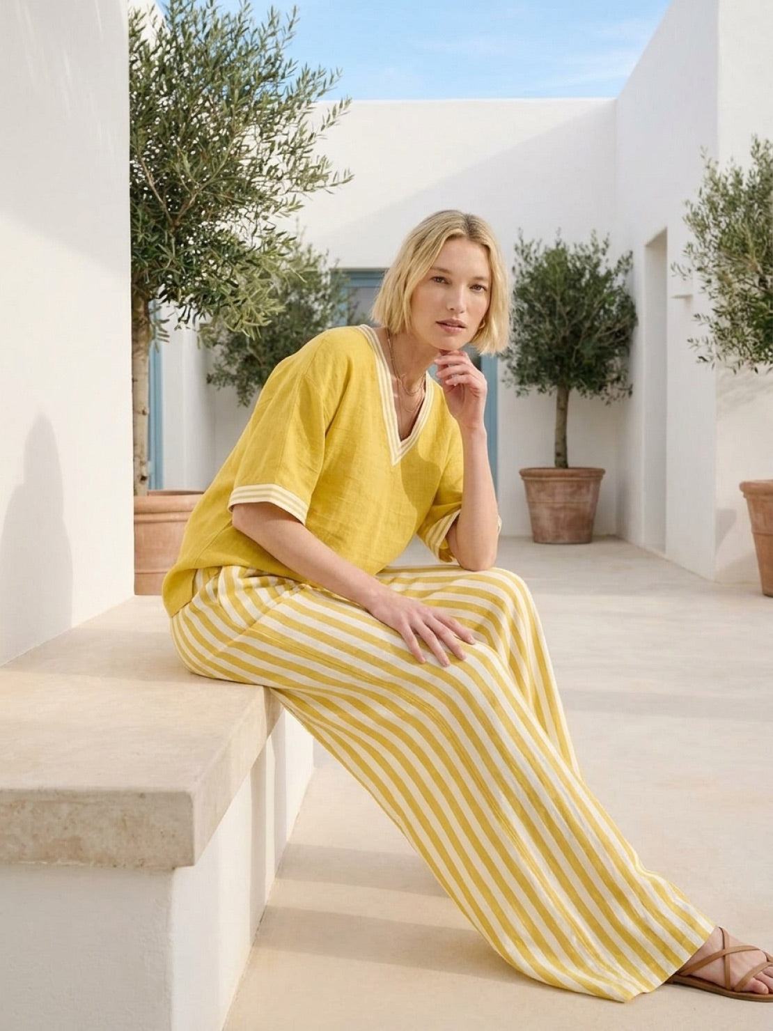 Woman wearing a striped wide-leg co-ord set with oversized top and palazzo pants