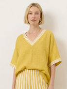 Woman wearing a striped wide-leg co-ord set with oversized top and palazzo pants with contrast stripe trim and elastic waist