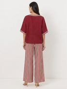 Woman wearing striped wide-leg co-ord set with oversized top and elastic waist palazzo pants