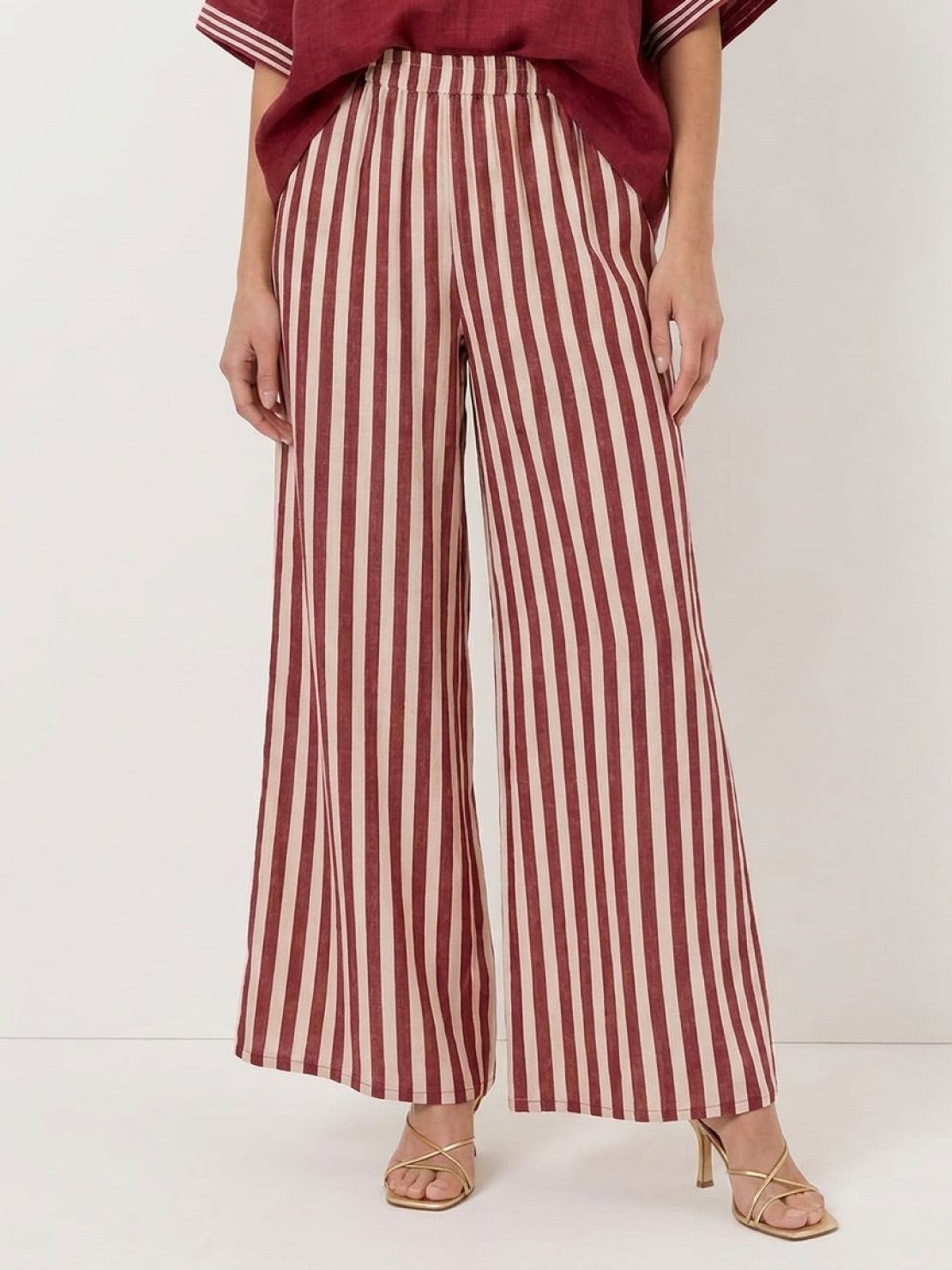 Woman wearing striped wide-leg co-ord set with oversized top and palazzo pants with elastic waist and side pockets