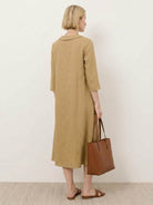 linen-look midi dress with relaxed A-line silhouette, blazer neckline, two-button detail, and side pockets in navy blue