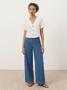 Lightweight 100% linen French top with relaxed boxy shape and three-button V-neck detail in light khaki