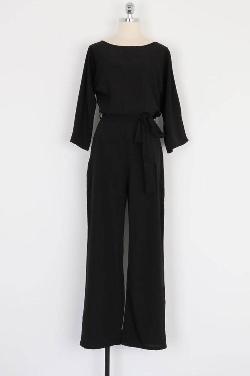 Black casual long sleeve belted jumpsuit with round neck and wide legs on mannequin