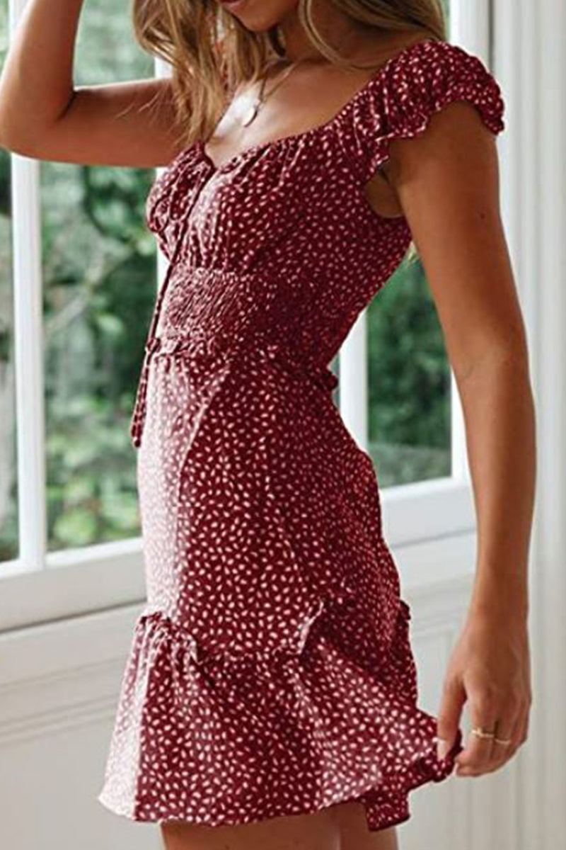 Woman wearing a red sweetheart collar printed ruffled maxi dress with a high waist and short sleeves.