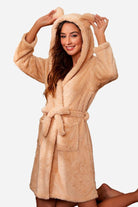 Woman wearing beige premium comfort nightgown bathrobe with hood and ears, belted waist, and front pockets