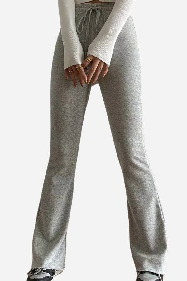 Woman wearing grey comfy wide-leg pants with elastic waistband and flared bottom