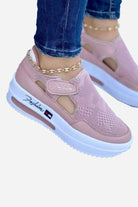 Pink breathable wedge sneakers with velcro closure and white non-slip sole, worn with jeans and anklet bracelet