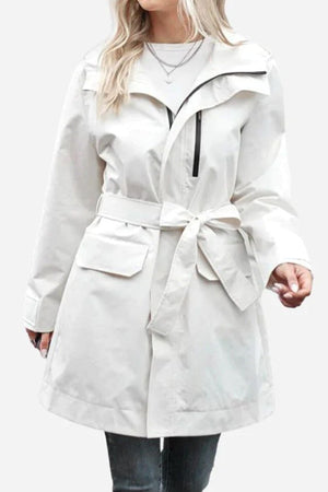 White water-resistant windbreaker trench jacket with belt and pockets on female model
