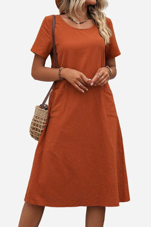 Radiant Escape Panelled Beach Dress midi-length A-line skirt soft polyester rust color with short sleeves and pockets worn with woven handbag