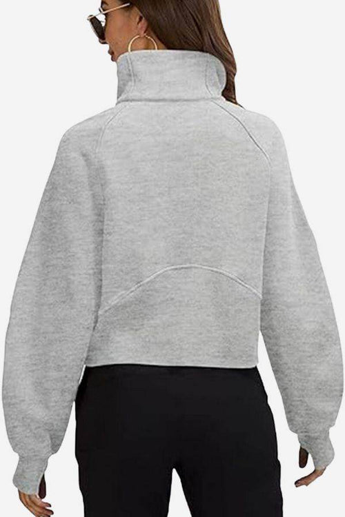 Back view of cozy oversized half-zip grey fleece pullover sweatshirt on woman