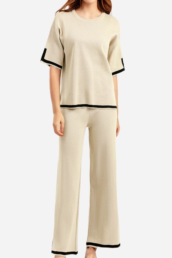 Short sleeved relaxed fit two-piece lounge set with black trim on beige short sleeve top and wide-leg pants