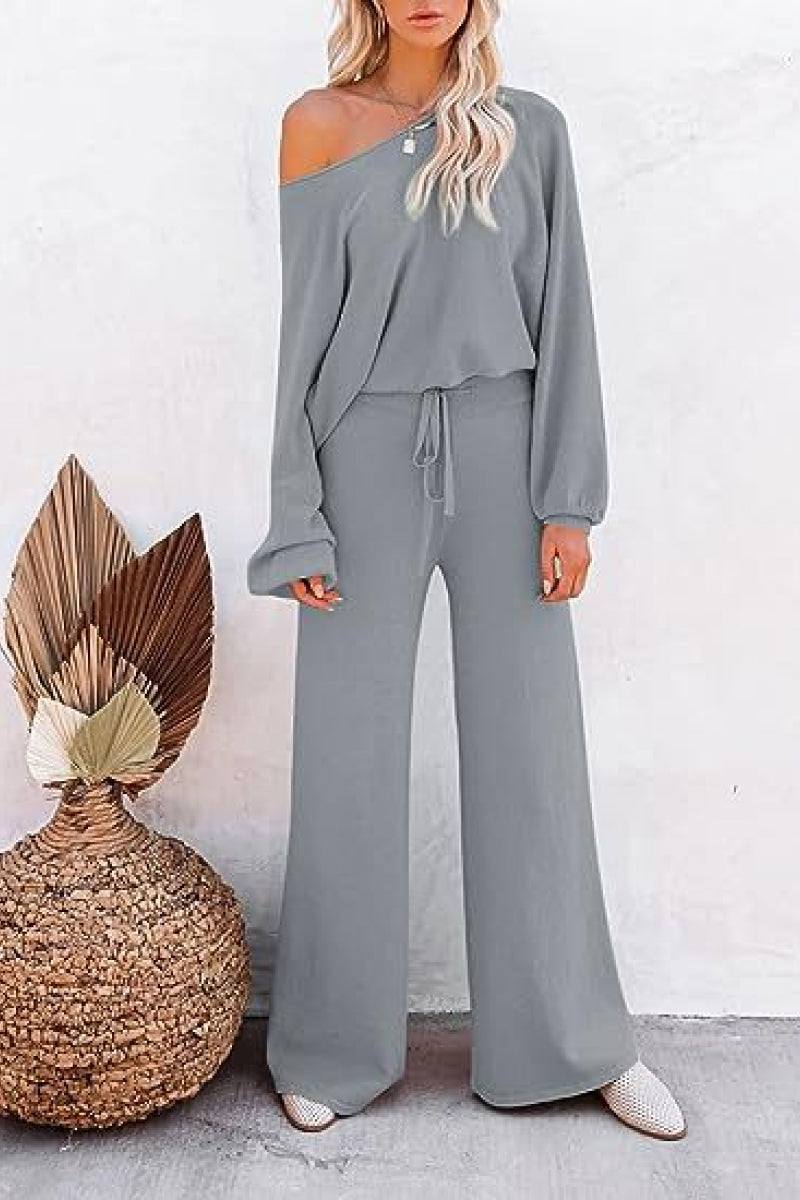 Woman wearing gray round neck loose fit cozy two-piece set with wide-leg pants and off-shoulder top