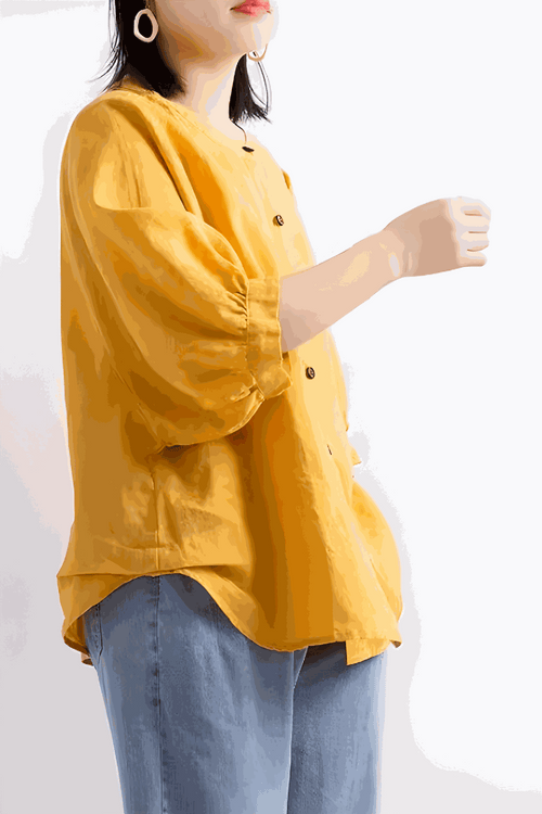 Relaxed loose breathable linen blouse in vibrant yellow with button-down front and puff sleeves worn with jeans