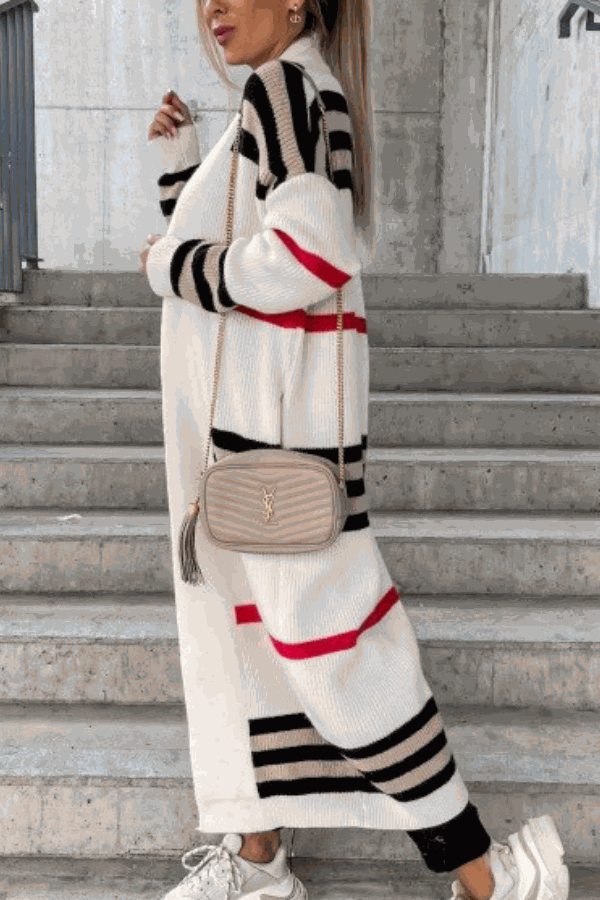 Cozy striped long knitted cardigan with oversized fit and soft fabric worn with crossbody bag and sneakers