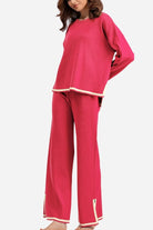 Long sleeved relaxed fit lounge two-piece set in pink with wide-leg palazzo pants and contrasting trim