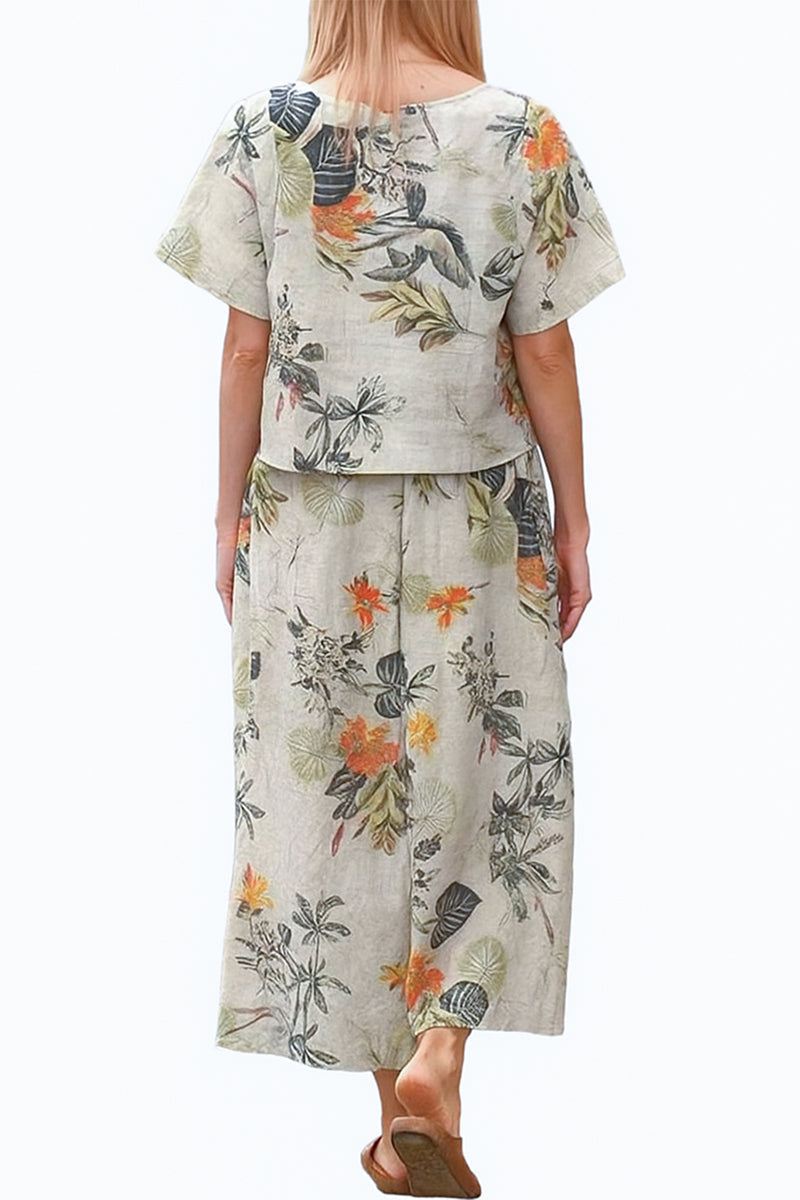 Woman wearing loose fit co-ord set with floral print wide-leg pants and short-sleeve top from Christmas Collection, back view