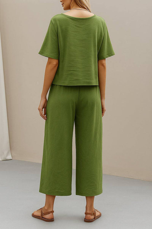 Woman wearing green loose fit co-ord set with wide-leg pants and short-sleeve top from the back