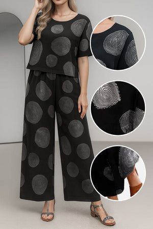 Black loose fit co-ord set with wide-leg pants and short-sleeve top featuring large gray circular patterns