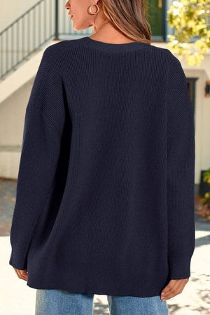Relaxed fit oversized navy knitwear cardigan back view on model outdoors