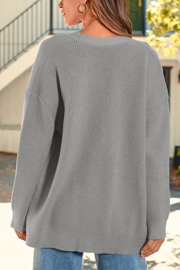 Back view of a woman wearing a gray relaxed fit oversized knitwear cardigan outdoors