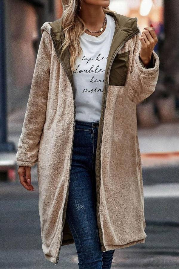 Woman wearing beige Sherpa-lined hooded teddy coat with olive green puffer details over casual outfit outdoors