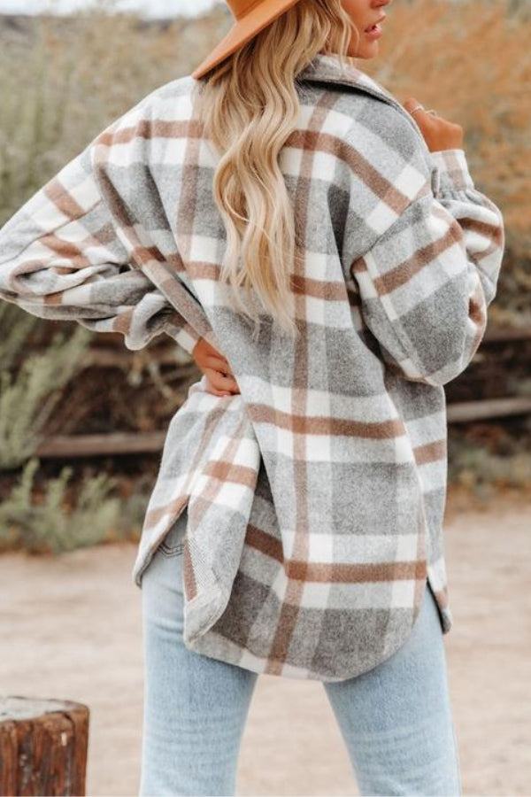 woman wearing comfy flannel classic button-down shirt in beige and grey plaid outdoors