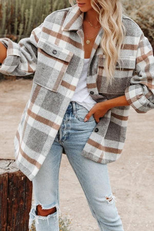 Woman wearing comfy flannel classic button-down shirt with plaid pattern and light washed ripped jeans outdoors