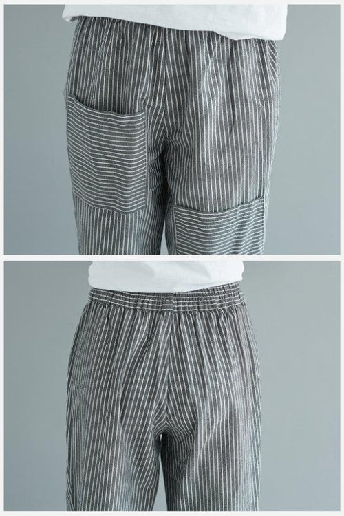 Close-up of high waist striped comfort pants with pockets and elastic waistband in gray and white stripes