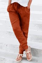 Women's relaxed chic elastic ankles pants in rust color, casual comfortable fit with drawstring waist and elastic cuffs.