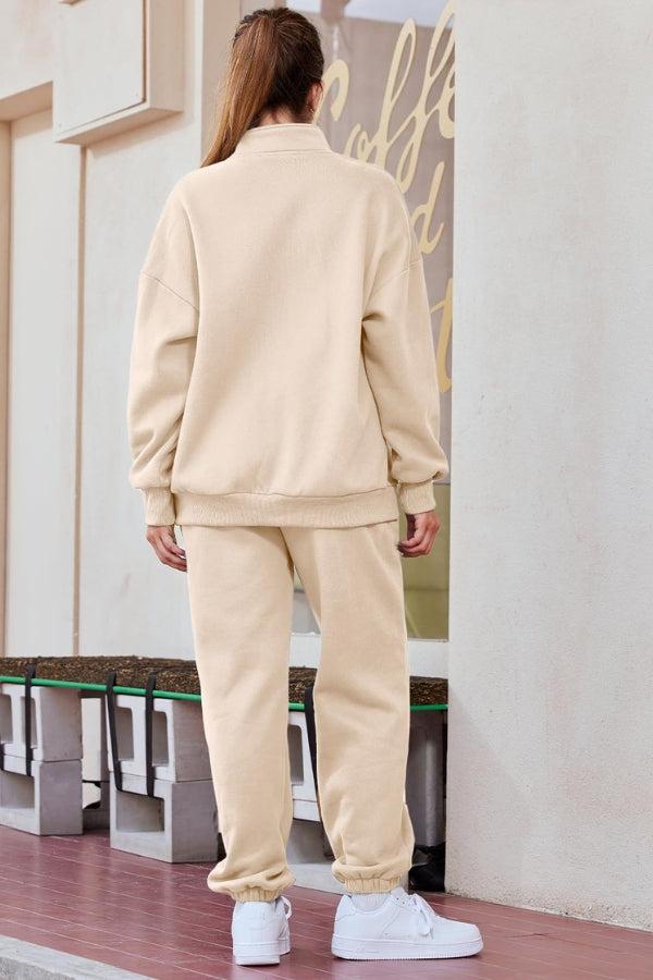 Woman wearing beige ultra-soft and comfy co-ord tracksuit set with white sneakers, seen from the back.