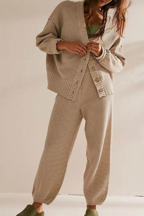 Woman wearing beige two-piece knitwear relaxed co-ord set with oversized cardigan and matching pants.