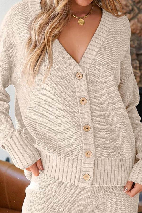 Woman wearing beige two-piece knitwear relaxed co-ord set with buttoned cardigan and matching pants