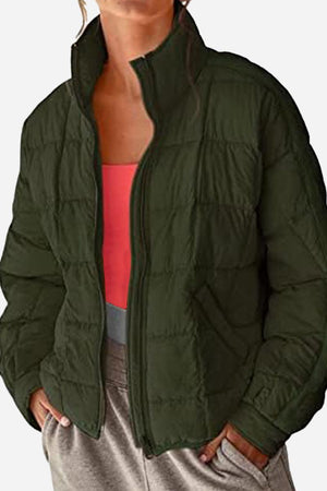 lightweight dark green puffer travel jacket with zip closure and stand collar for women