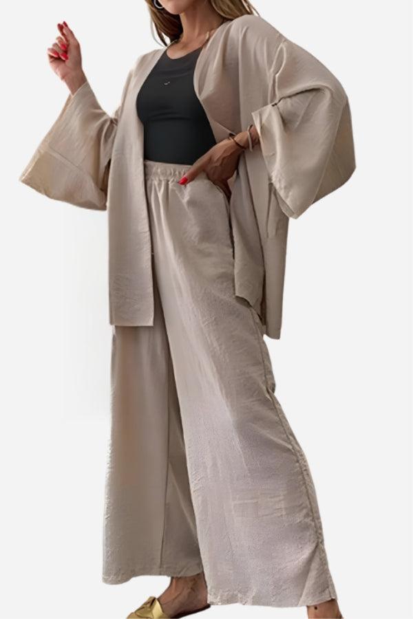 Woman wearing beige Chic Comfort Kimono two-piece set with wide sleeves and matching loose pants over black top