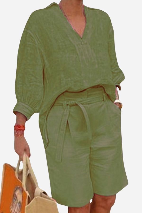 Olive green two-piece set with loose V-neck shirt and high-waisted knee-length shorts with belt and pockets