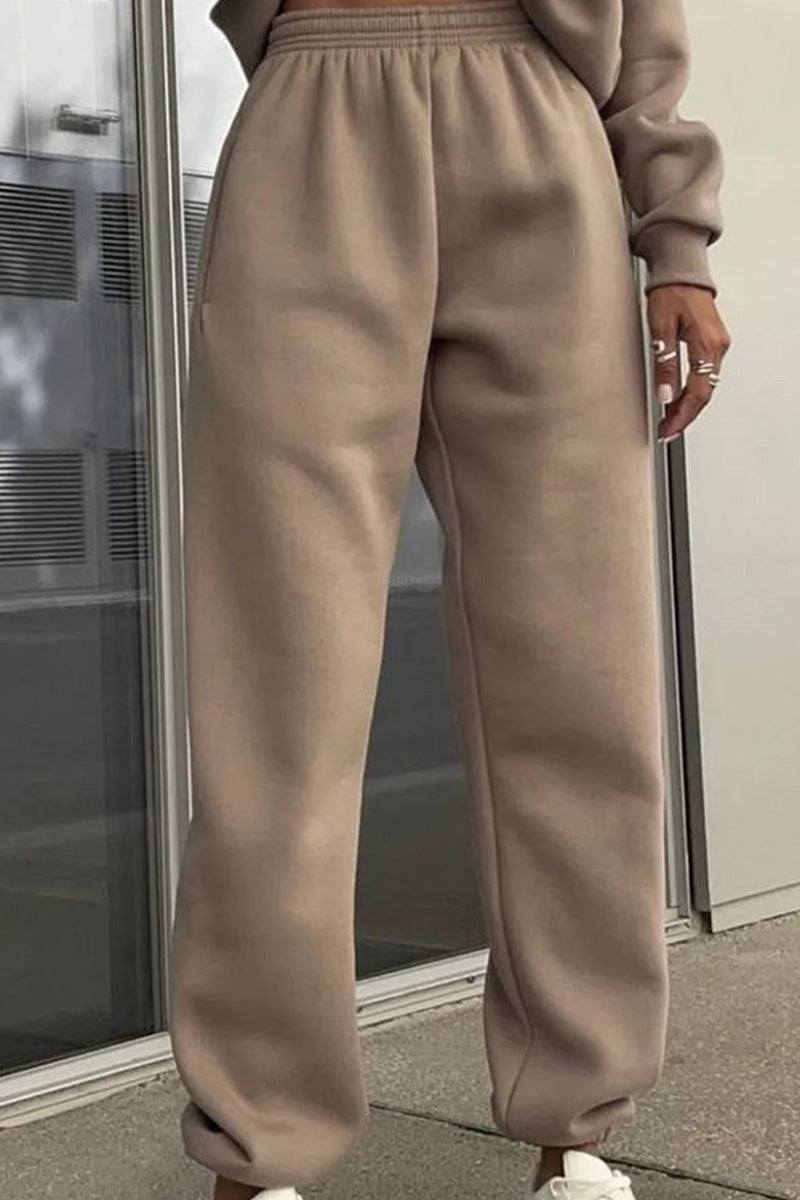 Beige cotton-blended two-piece tracksuit pants with elastic waistband and relaxed fit.