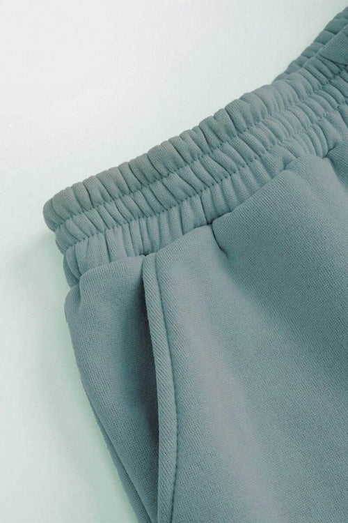 Close-up of gray cotton-blended two-piece tracksuit pants waistband and pocket detail