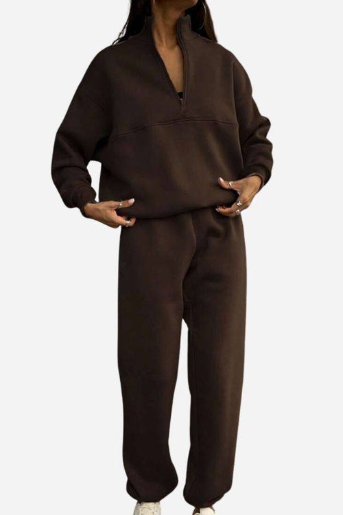 Woman wearing brown cotton-blended two-piece tracksuit with high collar and zipper