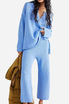 Woman wearing light blue textured two-piece oversized set holding a brown jacket Multi-Weather Comfort clothing