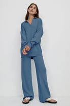 woman wearing blue plush and preppy two-piece set with polo collar and wide-leg pants