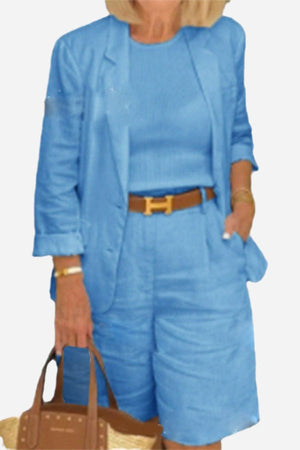 Blue blazer and high-waisted shorts two-piece set with rolled-up sleeves and matching top.
