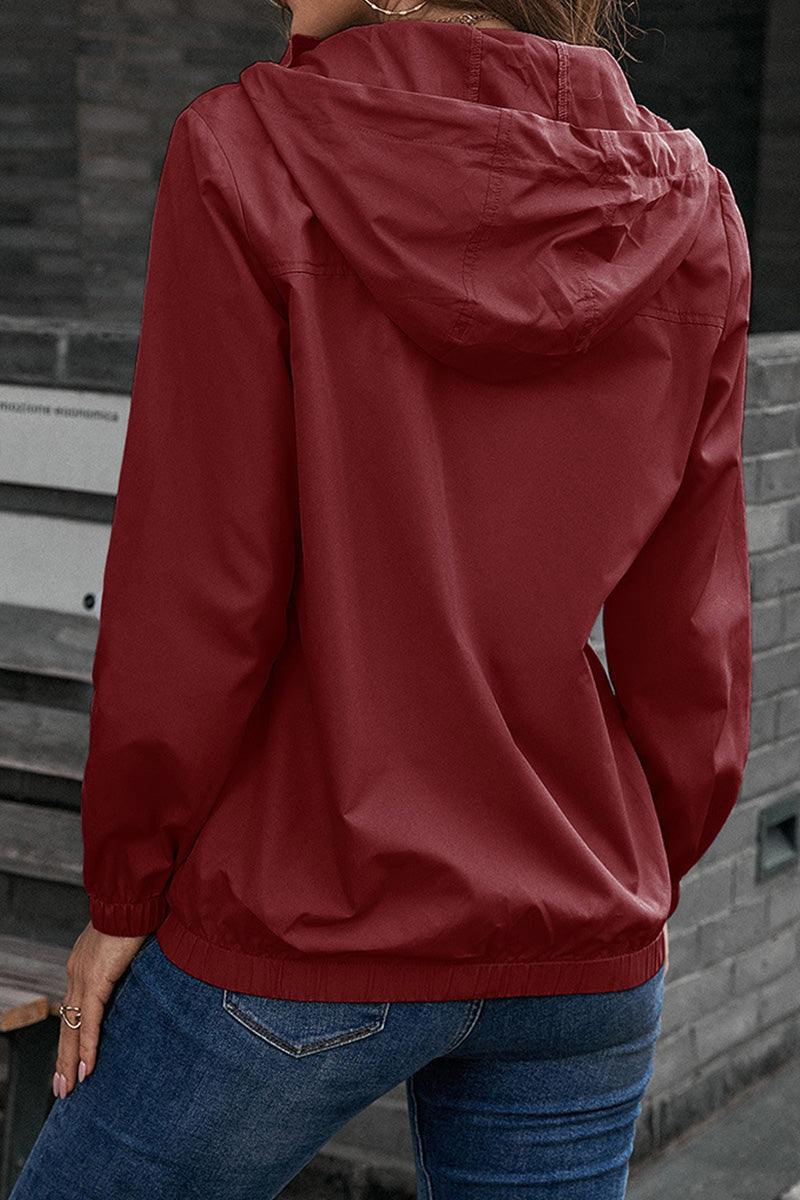 Red outdoor hooded raincoat and windbreaker with elastic cuffs and hem, worn with blue jeans, shown from the back