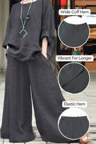 Black wide leg pants with pockets, wide cuff hem, elastic hem, and vibrant color retention