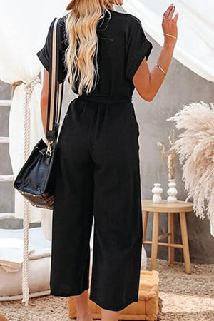 Black V-neck lace-up pocket jumpsuit with tie waist and wide legs, stylish and comfortable for casual or dressy occasions.